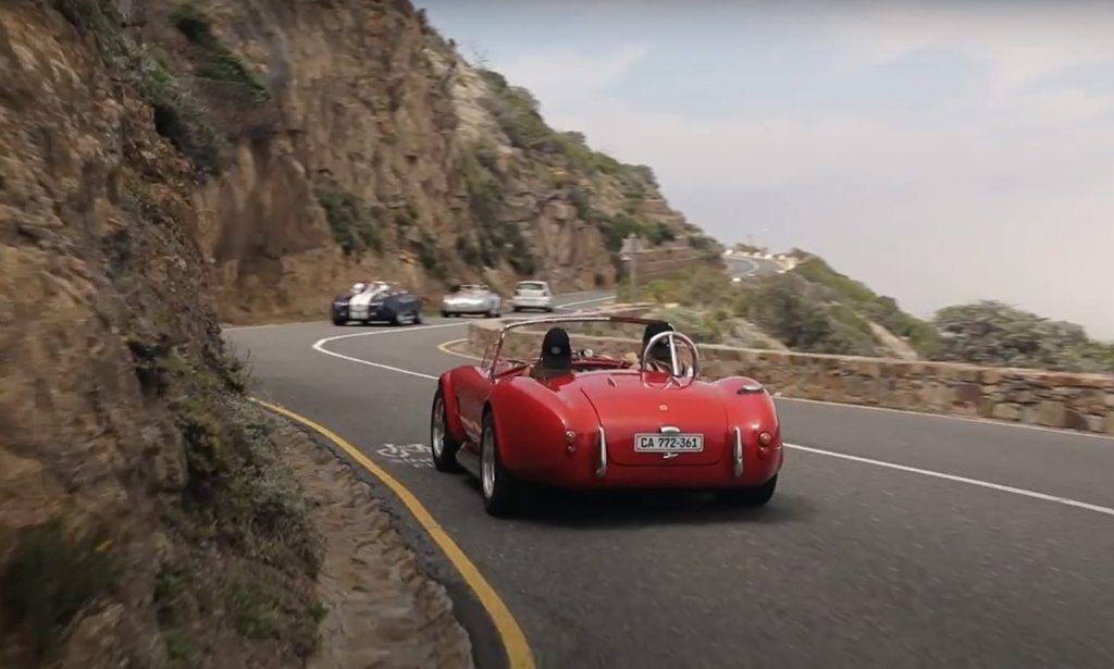 The breathtaking coastal road with a red car