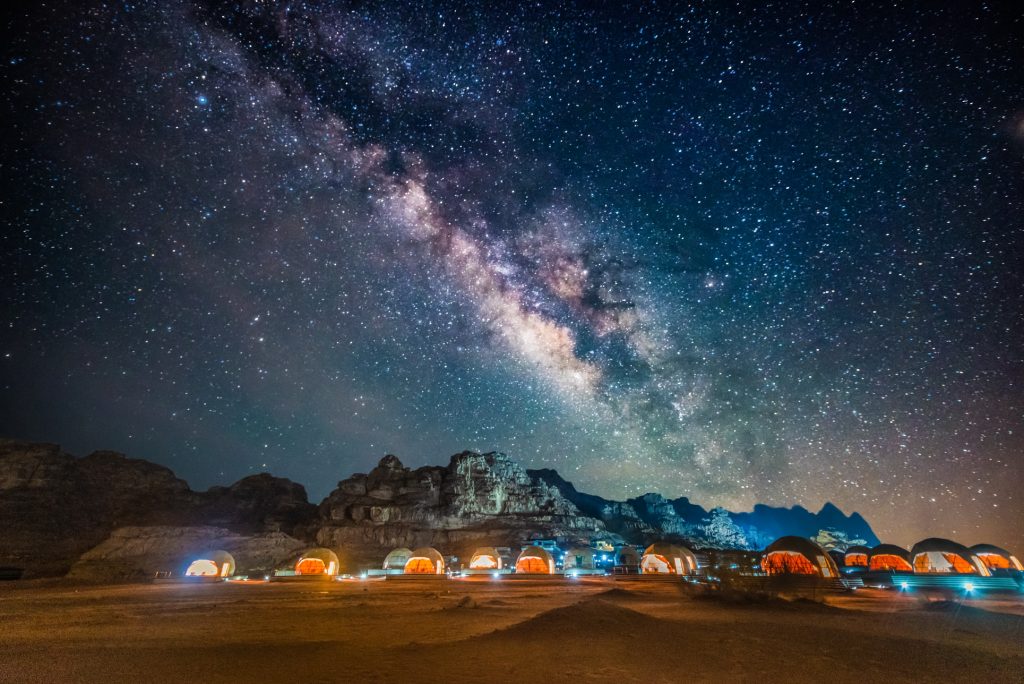 Milky Way over a desert camp in the red desert of Wadi Rum in Jordan