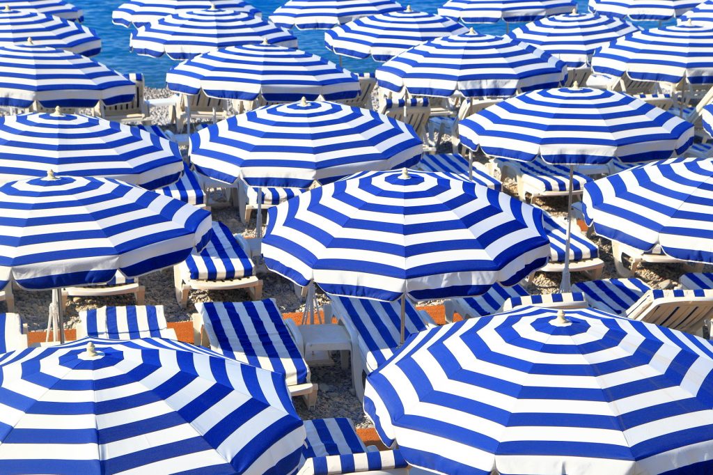 Coloured umbrellas on the beach of Nice, Côte d'Azur, France