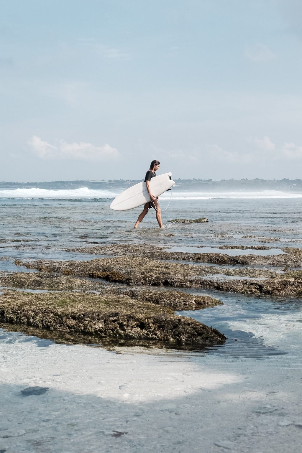 Surfer walking towards the waves