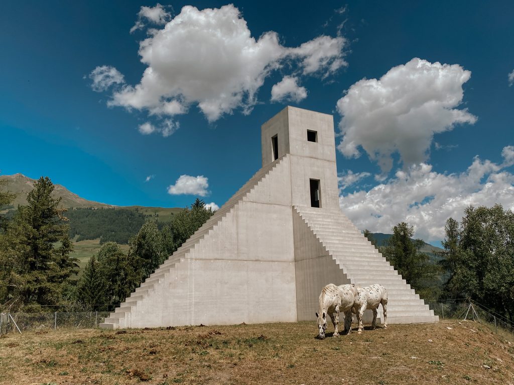 horse grazing near monumental architecture